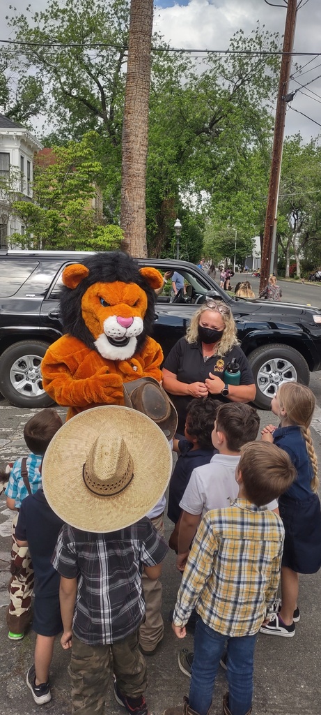 Rory the Royal Lion greeting students.
